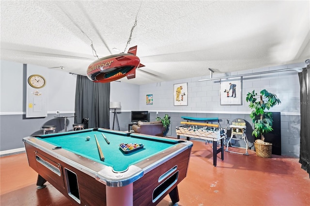 playroom with a textured ceiling, billiards, and concrete flooring