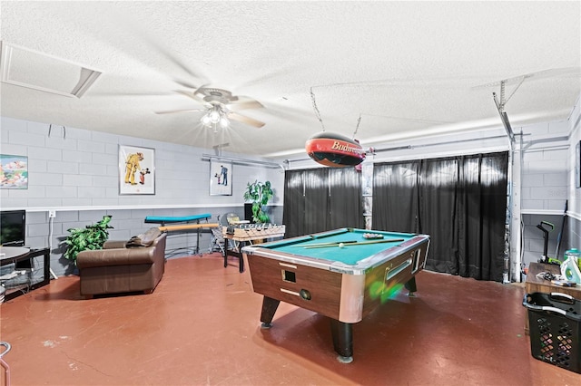 playroom with concrete floors, a textured ceiling, billiards, and ceiling fan