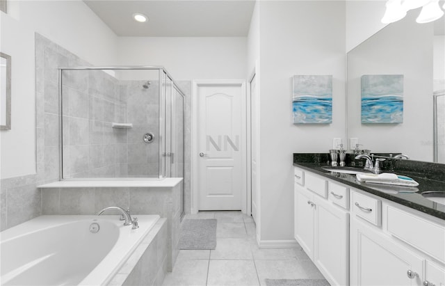 bathroom featuring separate shower and tub, vanity, and tile patterned floors