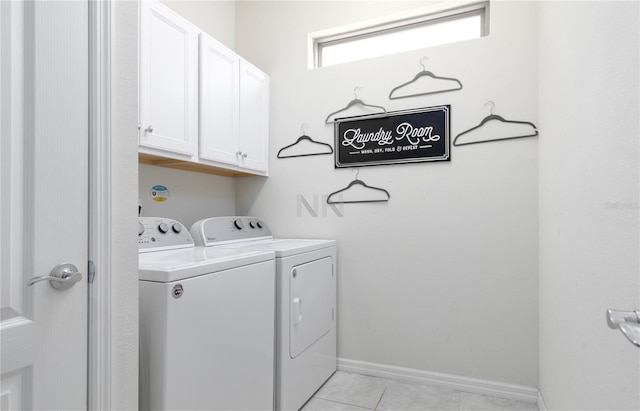 laundry area with cabinets, light tile patterned flooring, and washing machine and clothes dryer