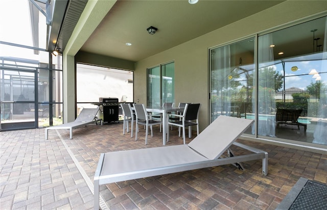 view of patio / terrace featuring a lanai and grilling area