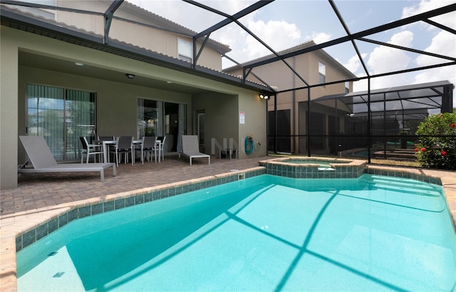 view of swimming pool featuring a lanai, a patio, and an in ground hot tub