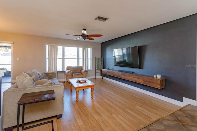 living room featuring ceiling fan and light wood-type flooring