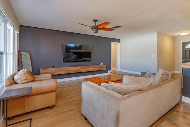 living room featuring ceiling fan and light hardwood / wood-style floors