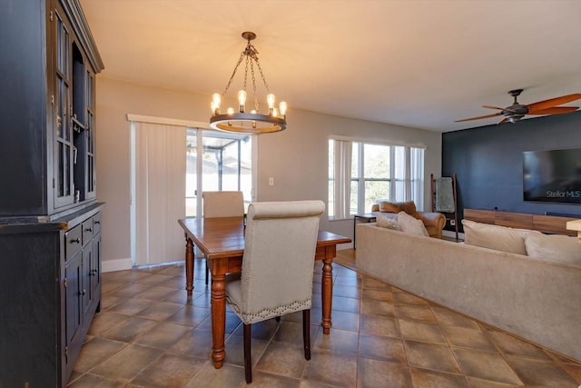 dining area featuring ceiling fan with notable chandelier