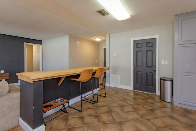 kitchen with a breakfast bar and wooden counters