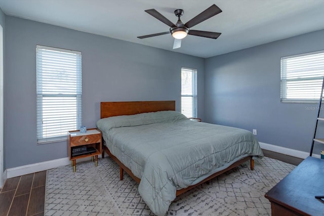 bedroom with hardwood / wood-style floors and ceiling fan