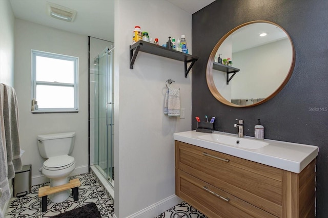 bathroom with tile patterned flooring, vanity, an enclosed shower, and toilet