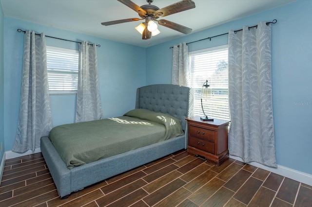 bedroom with ceiling fan and multiple windows