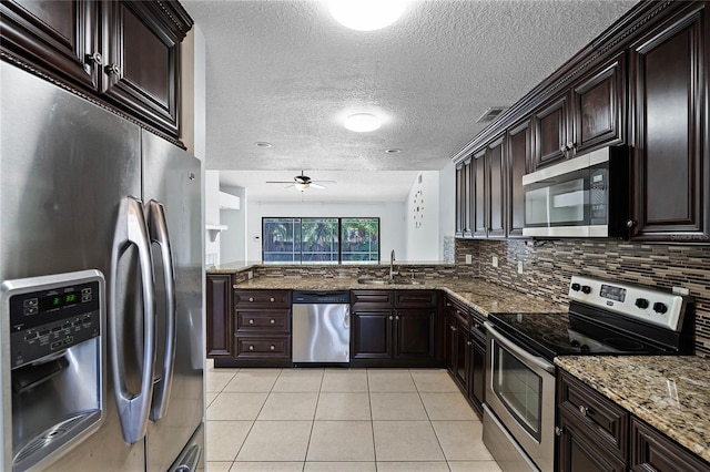 kitchen featuring sink, dark brown cabinetry, and appliances with stainless steel finishes