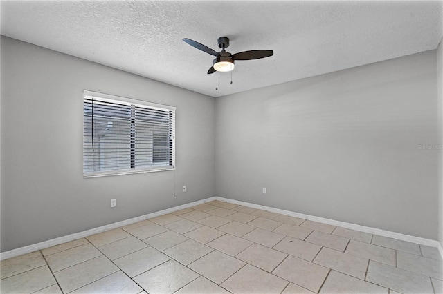 tiled spare room featuring ceiling fan and a textured ceiling