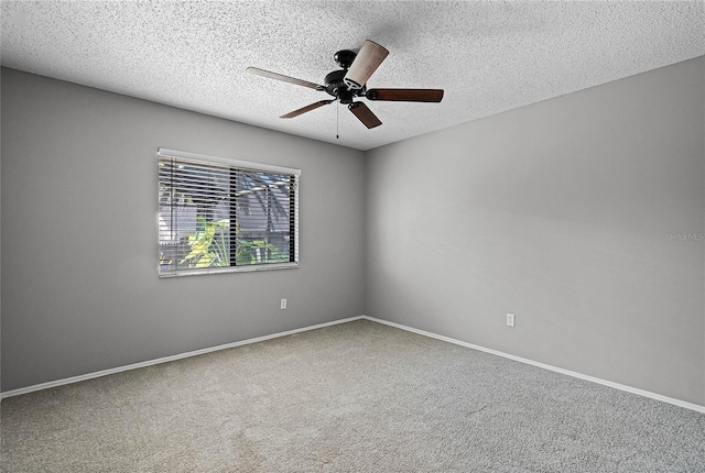 unfurnished room featuring a textured ceiling, ceiling fan, and carpet