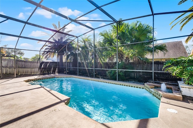 view of swimming pool featuring a patio, glass enclosure, and pool water feature