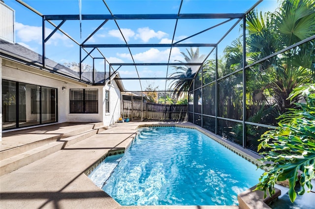 view of pool featuring a patio area and glass enclosure