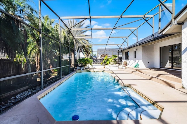 view of pool featuring a patio area, glass enclosure, and pool water feature