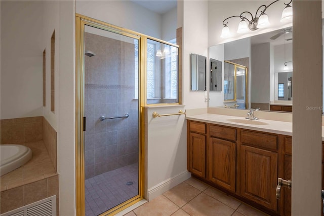 bathroom featuring vanity, tile patterned floors, and shower with separate bathtub