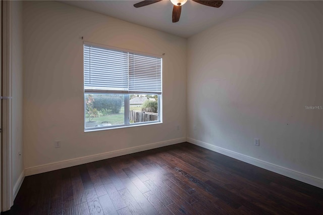 empty room featuring dark wood-type flooring and ceiling fan