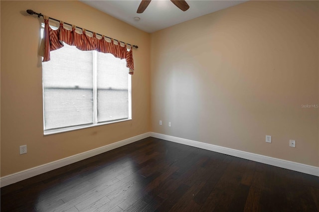 spare room with ceiling fan and dark hardwood / wood-style flooring