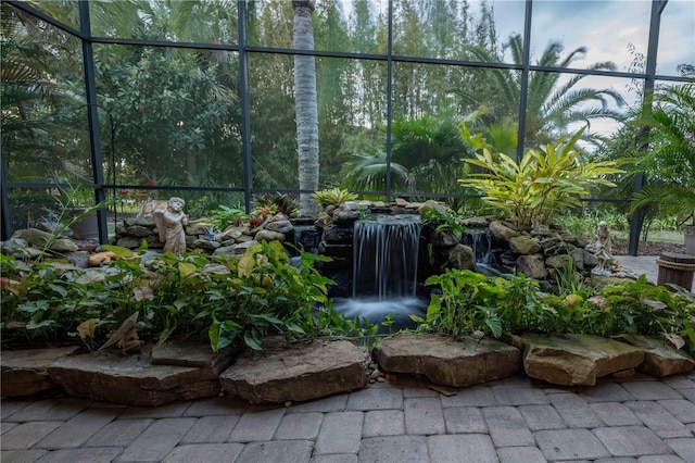 view of patio / terrace featuring glass enclosure