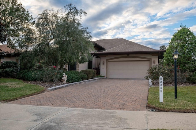 view of front of home featuring a garage and a front lawn