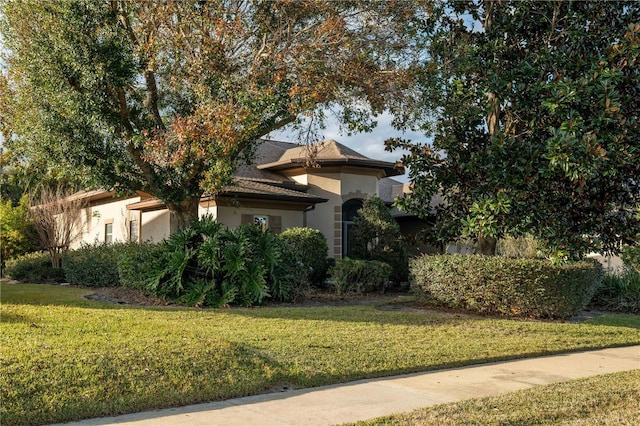 view of side of property with a yard