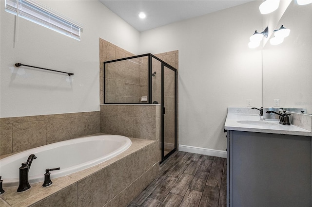 bathroom with vanity and separate shower and tub