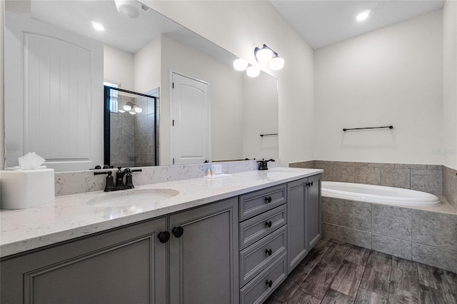 bathroom featuring vanity and shower with separate bathtub