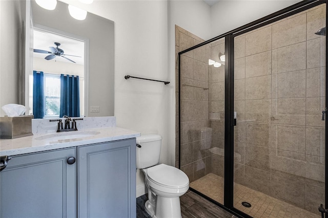 bathroom with hardwood / wood-style floors, vanity, walk in shower, and ceiling fan