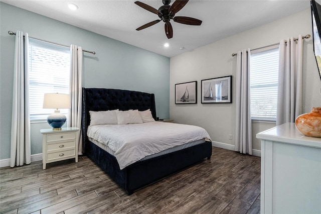 bedroom with multiple windows, dark hardwood / wood-style floors, and ceiling fan