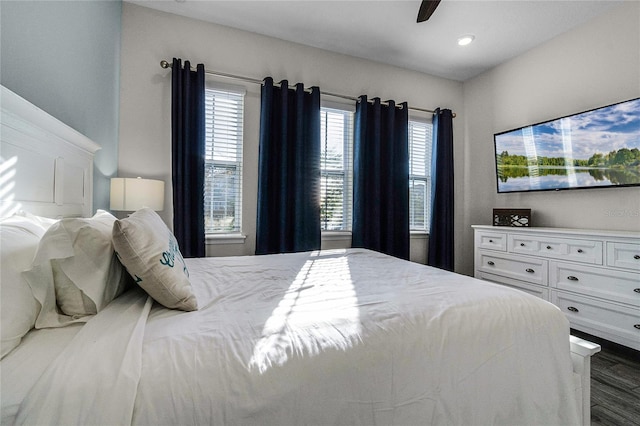 bedroom with ceiling fan and dark hardwood / wood-style flooring