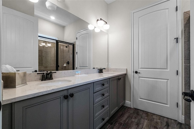 bathroom with vanity, wood-type flooring, and walk in shower