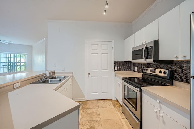 kitchen featuring sink, decorative backsplash, ceiling fan, white cabinetry, and stainless steel appliances