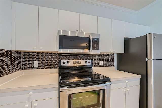 kitchen with stainless steel appliances, white cabinetry, tasteful backsplash, and ornamental molding