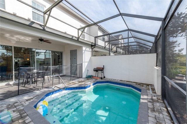 view of pool featuring a patio area, ceiling fan, and glass enclosure