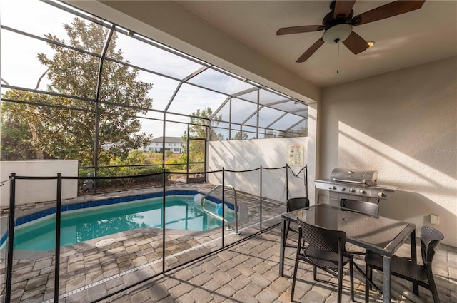 view of pool featuring a grill, ceiling fan, a patio, and glass enclosure