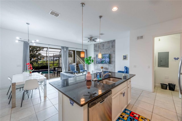 kitchen with dishwasher, a center island with sink, ceiling fan with notable chandelier, sink, and light tile patterned floors