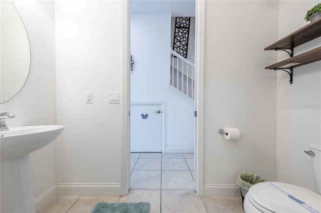 bathroom featuring tile patterned floors and toilet