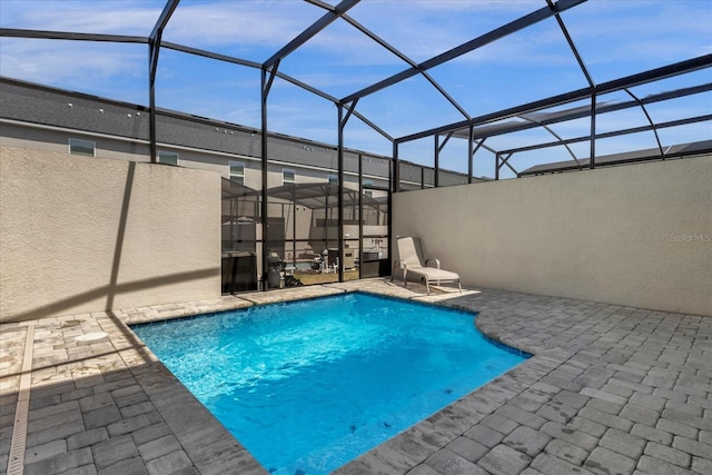 view of pool with a lanai, central AC unit, and a patio