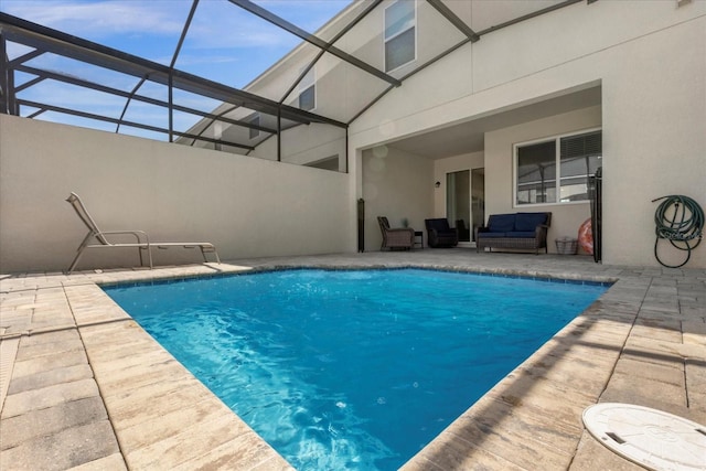 view of swimming pool with a lanai, an outdoor hangout area, and a patio