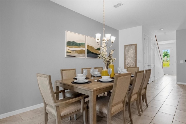 dining room featuring an inviting chandelier and light tile patterned flooring