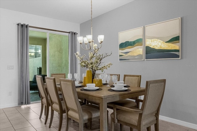 tiled dining room featuring a chandelier