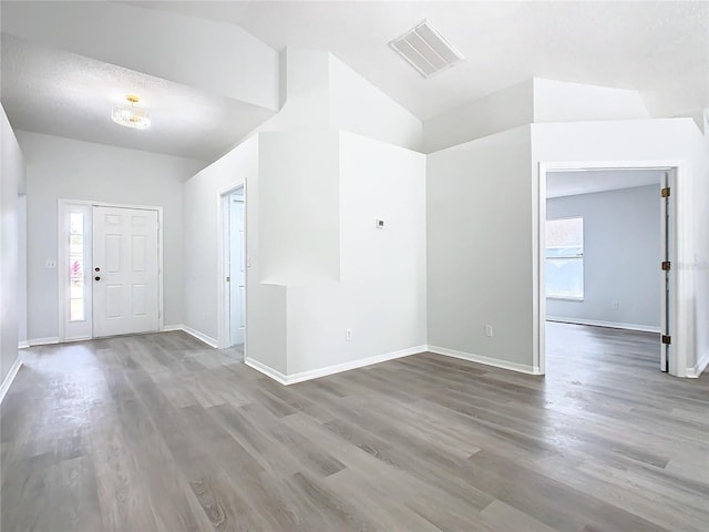 entrance foyer featuring hardwood / wood-style flooring and lofted ceiling