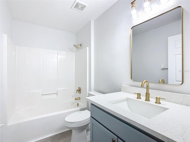 full bathroom with toilet, vanity,  shower combination, and hardwood / wood-style flooring