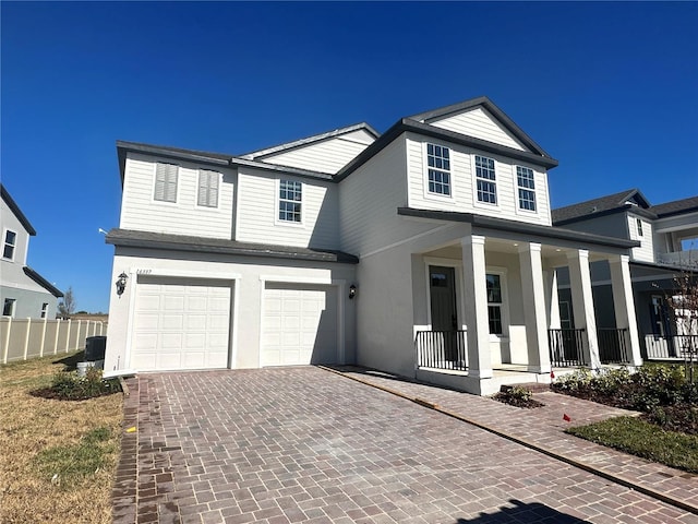 view of front of property featuring covered porch and a garage