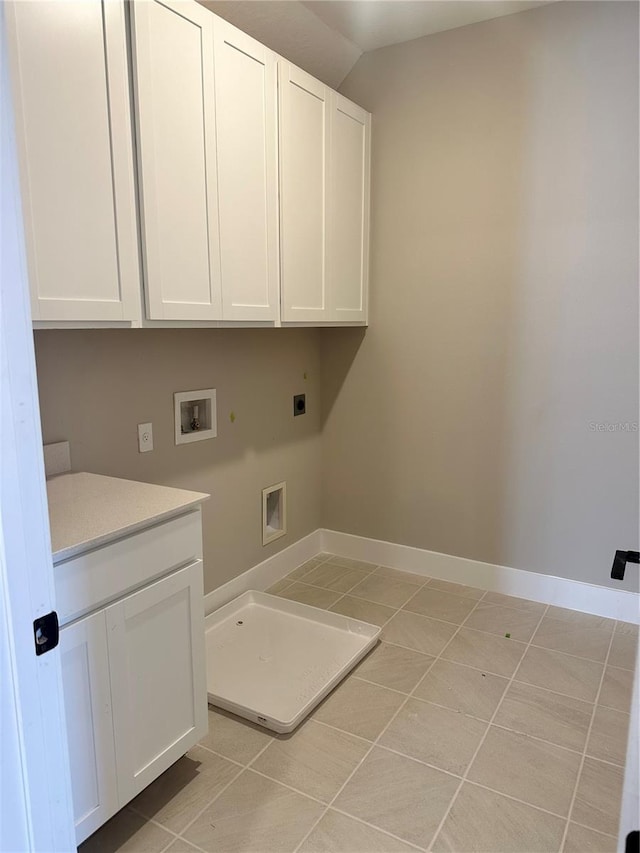 washroom with light tile patterned flooring, hookup for a washing machine, cabinets, and hookup for an electric dryer