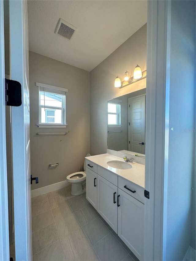 bathroom with toilet and vanity