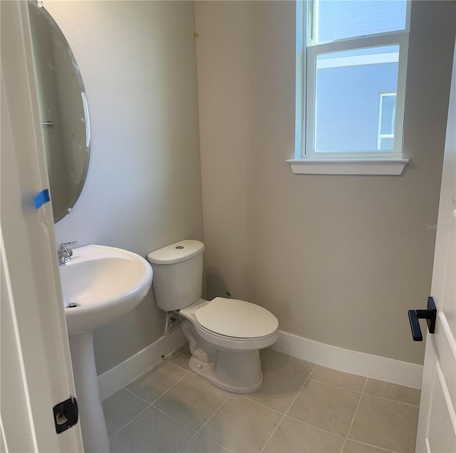 bathroom featuring tile patterned flooring and toilet