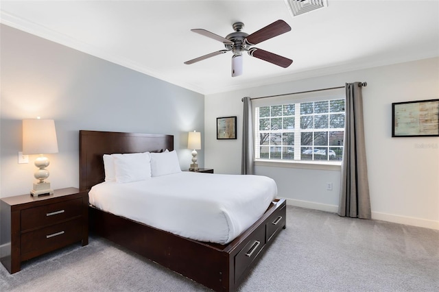 carpeted bedroom featuring ceiling fan and ornamental molding