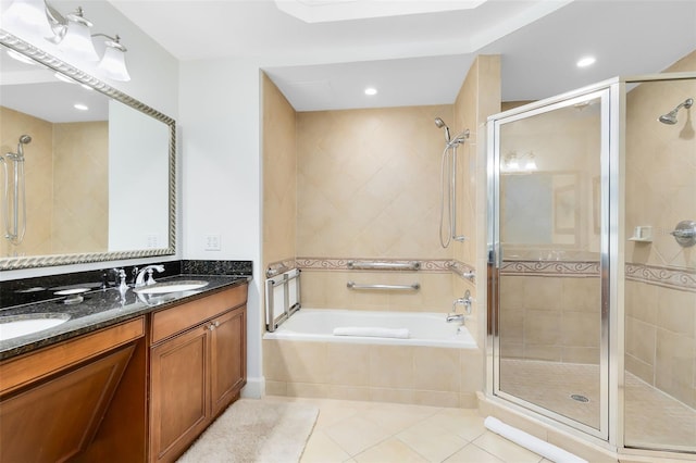 bathroom with tile patterned floors, vanity, and separate shower and tub