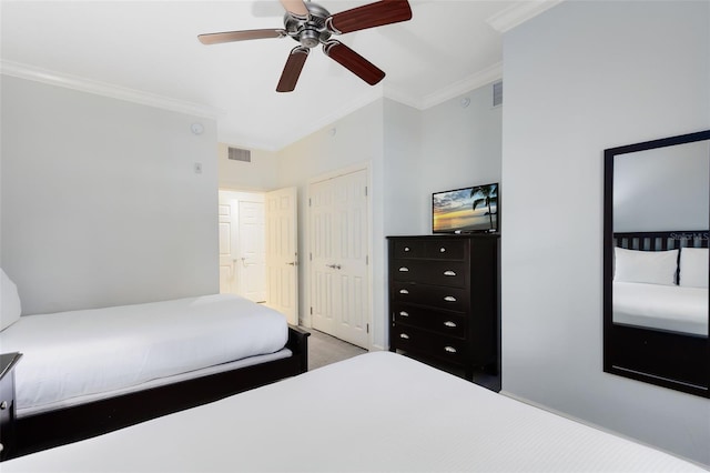 carpeted bedroom with ceiling fan and crown molding